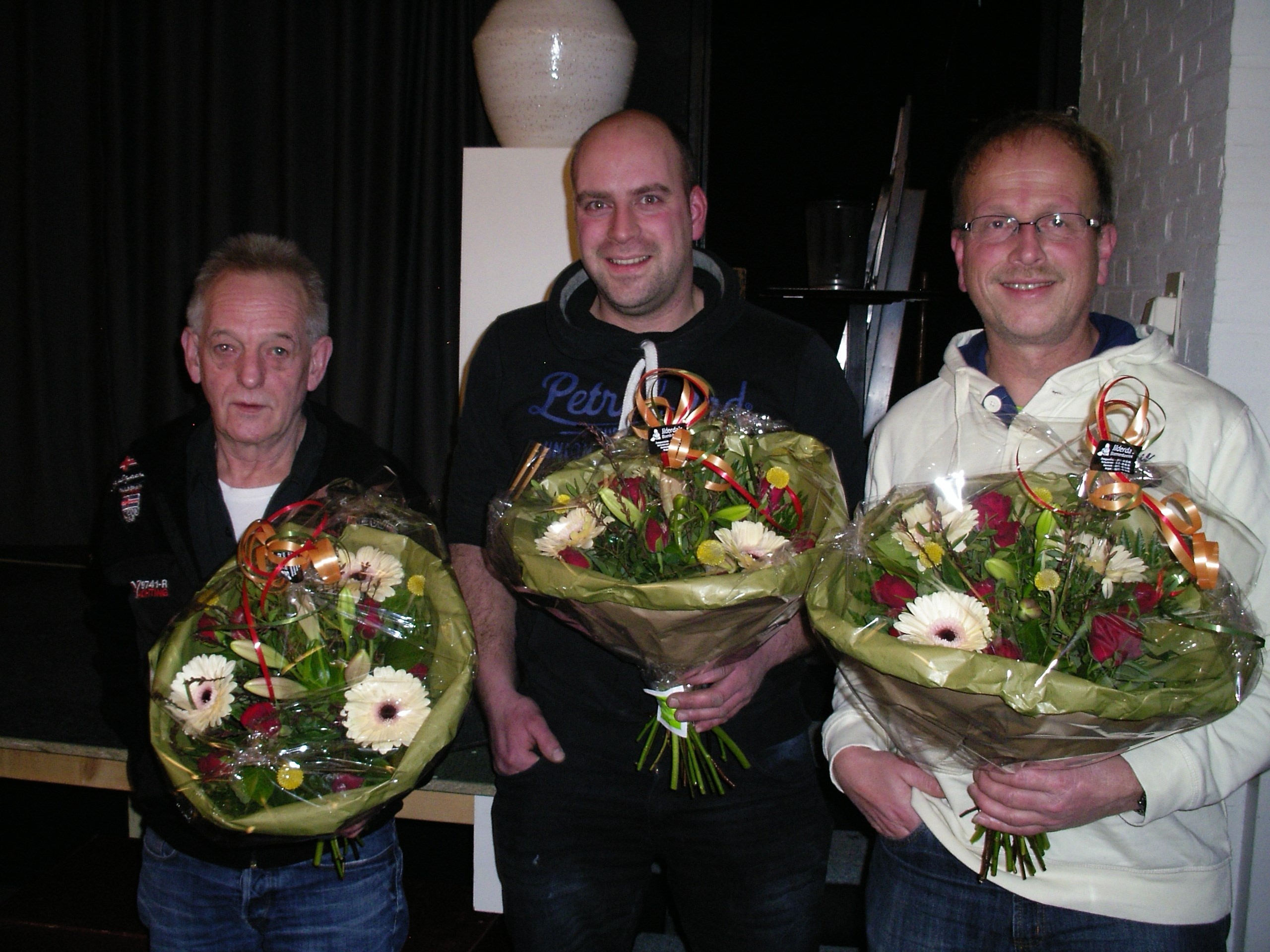 Van links naar rechts AT Vissia, J Andringa en H Pel, W Weening heeft de bloemen thuisbezorgd gekregen
